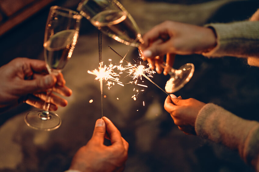 祝朋友新年快樂:人們舉著煙火乾杯